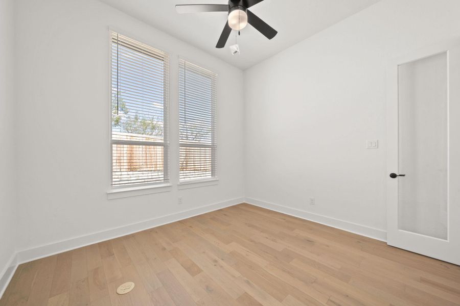Spare room with light wood-style floors and a ceiling fan