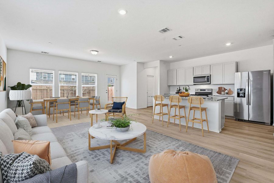 Open-concept living space featuring wood-finish flooring throughout Open-concept living space featuring wood-finish flooring throughout