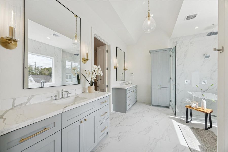 Spa-like bath with a freestanding tub, large shower, dual vanities, and beautiful finishes.