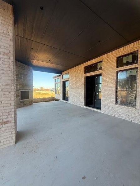 Covered patio offers beautiful double glass doors. Lots of windows for natural light.