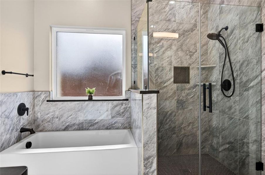 Soaking Tub and Floor to Ceiling Tile Shower