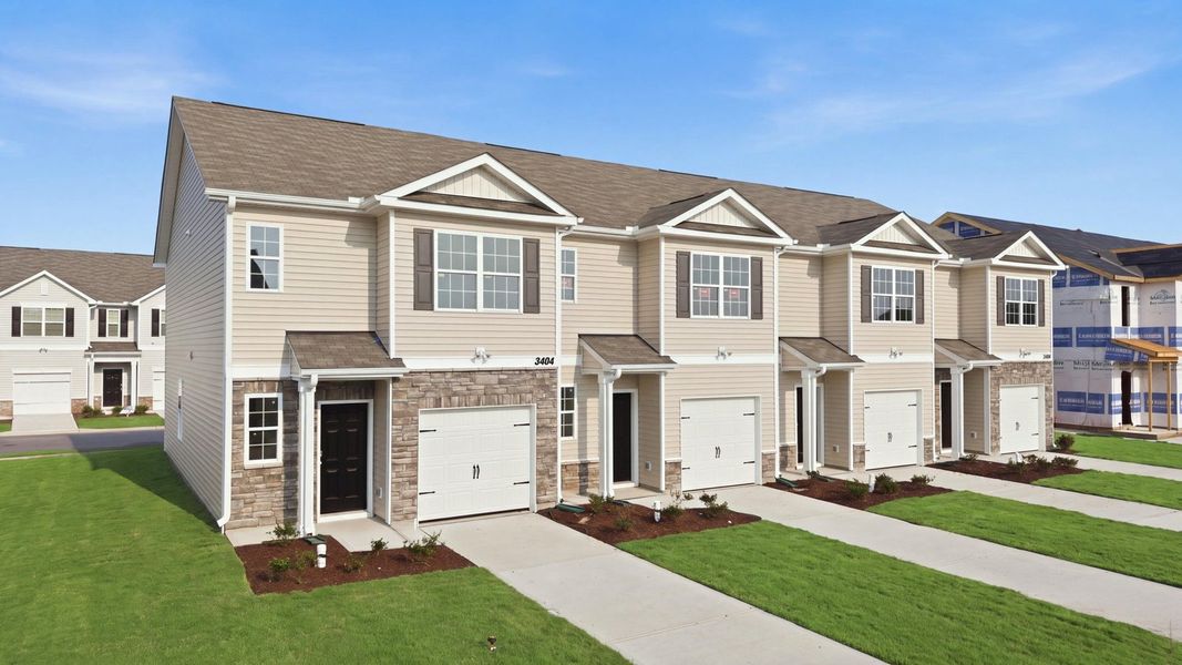 Front exterior of a new home in The Townes at Ridgewood Farms, Winterville, NC, highlighting curb appeal (Image 1). Front exterior of a new home in The Townes at Ridgewood Farms, Winterville, NC, highlighting curb appeal (Image 1).