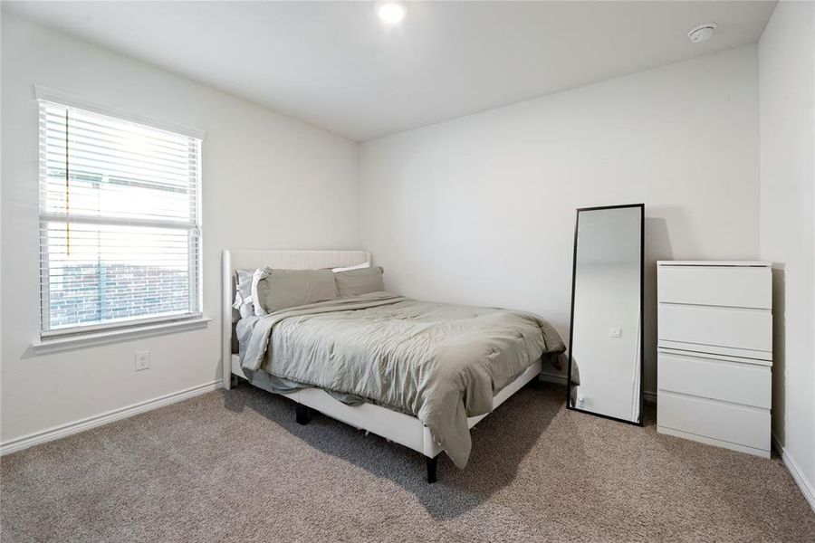 Carpeted bedroom with baseboards