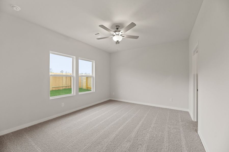 A room with a ceiling fan and a window. A room with a ceiling fan and a window.