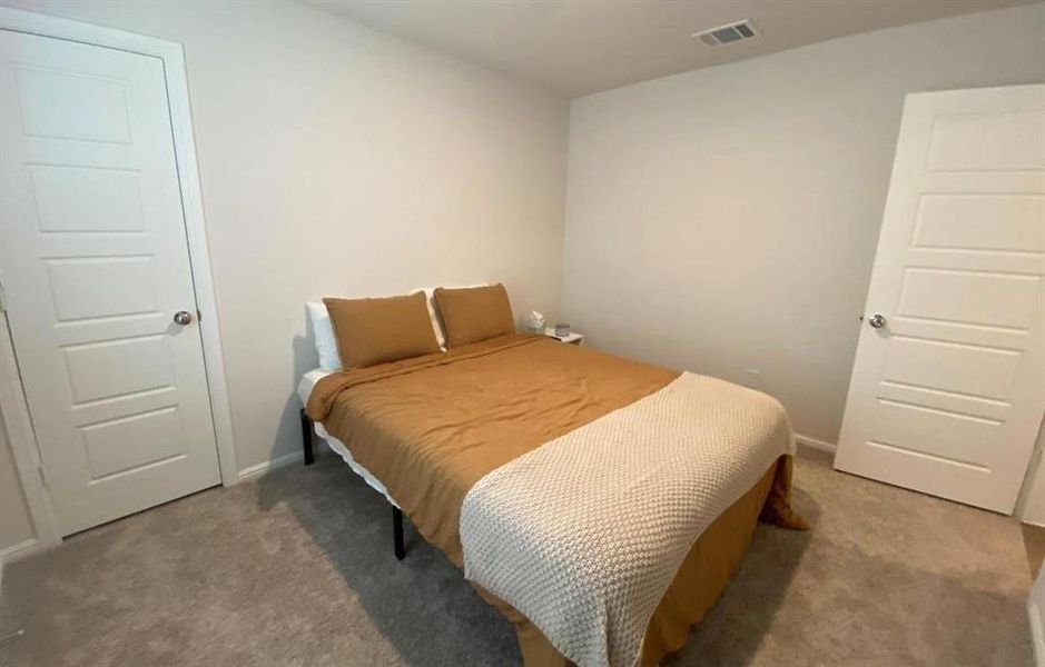 Bedroom featuring carpet and baseboards Bedroom featuring carpet and baseboards