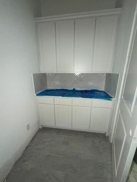 Bathroom featuring tasteful backsplash and vanity