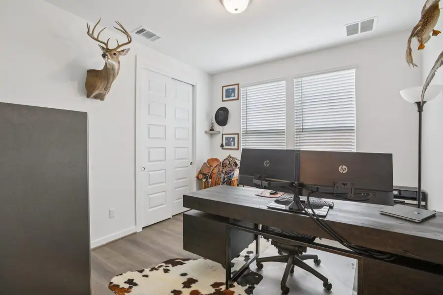 Office area with wood finished floors and baseboards Office area with wood finished floors and baseboards