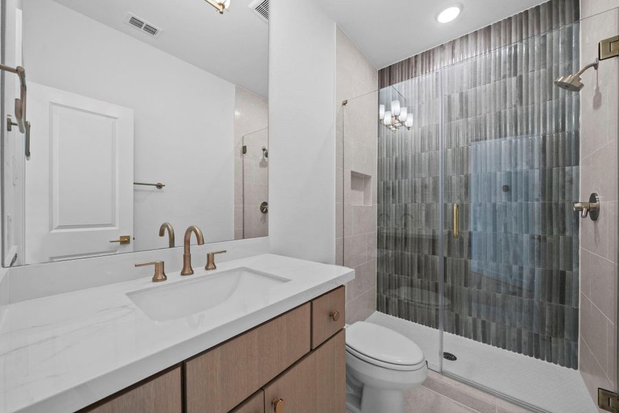 Elegant bathroom featuring glass enclosed shower, refined finishes, and a spacious layout.