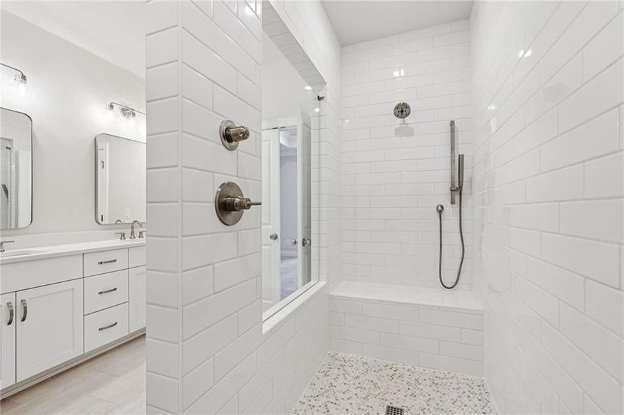 Bathroom with double vanity and a walk in shower