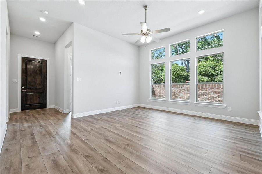 Unfurnished living room featuring recessed lighting, a ceiling fan, and light wood-style floors Unfurnished living room featuring recessed lighting, a ceiling fan, and light wood-style floors