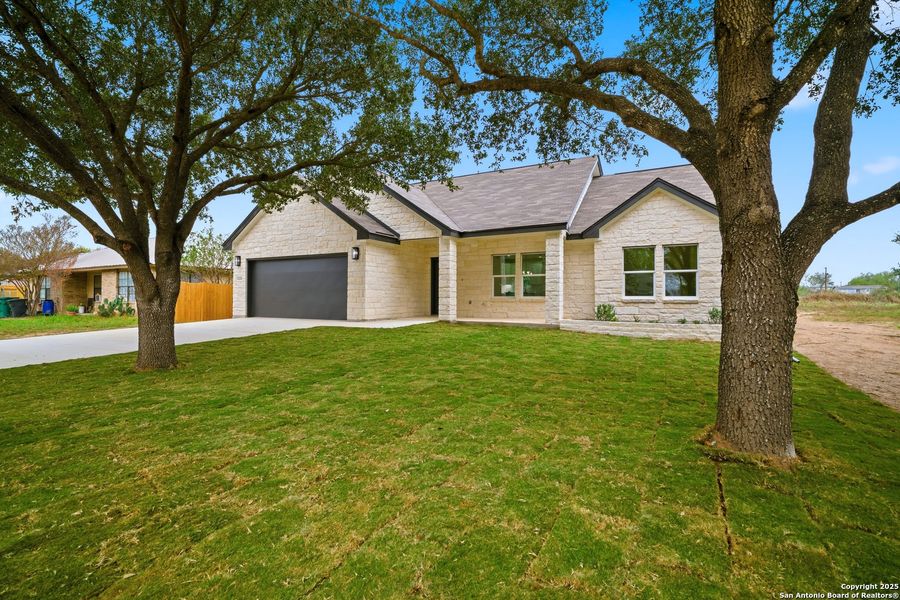 Front exterior of a new home in , Lytle, TX, highlighting curb appeal (Image 17).