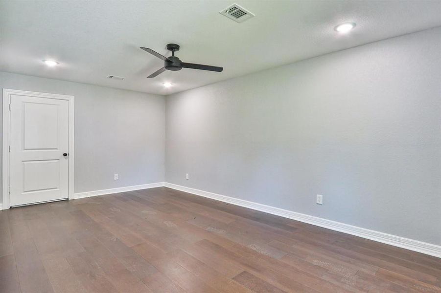 An additional bonus room off the garage with engineered wood flooring and recessed canned lights.