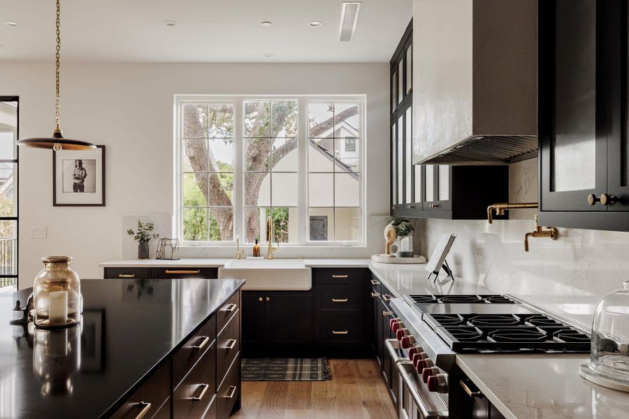 The statement island, crafted from honed stone, anchors the room as both a workspace and a gathering hub, perfectly scaled for everyday living or large-scale entertaining. The statement island, crafted from honed stone, anchors the room as both a workspace and a gathering hub, perfectly scaled for everyday living or large-scale entertaining.