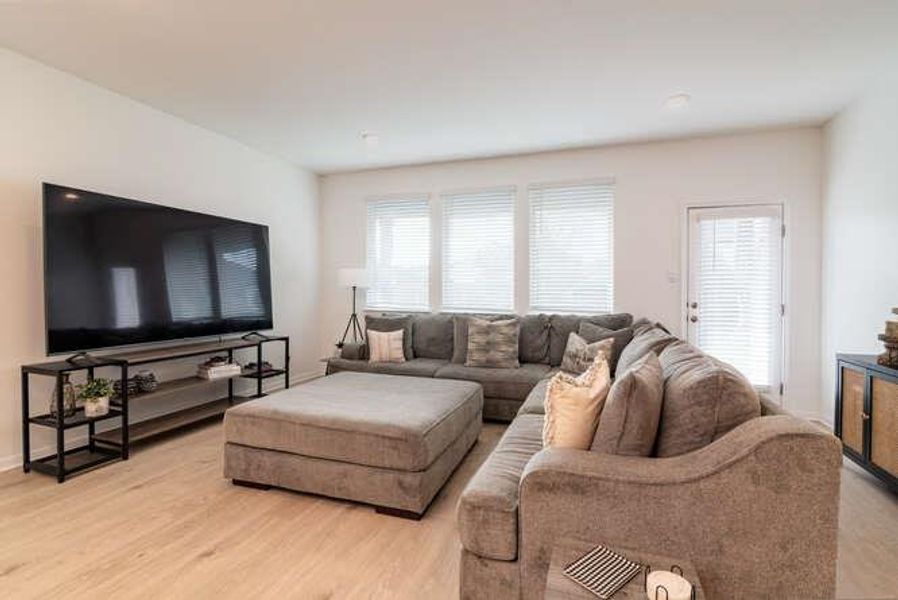 Living area featuring healthy amount of natural light and light wood finished floors