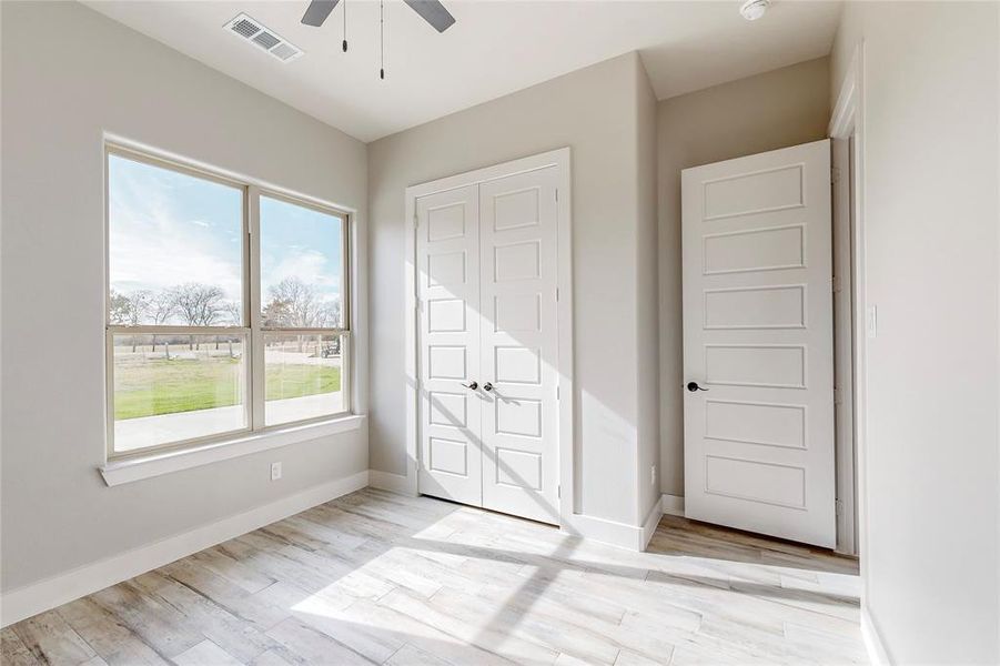 Unfurnished bedroom featuring light hardwood / wood-style flooring and ceiling fan