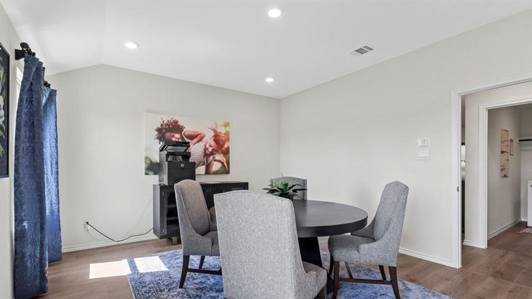 Dining space featuring dark wood-style floors and recessed lighting