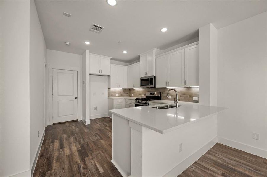 The oversized kitchen peninsula offers the perfect place for a quick meal.