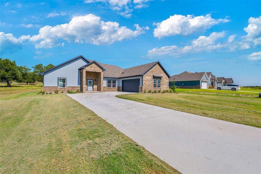 Front exterior of a new home in , Azle, TX, highlighting curb appeal (Image 2).