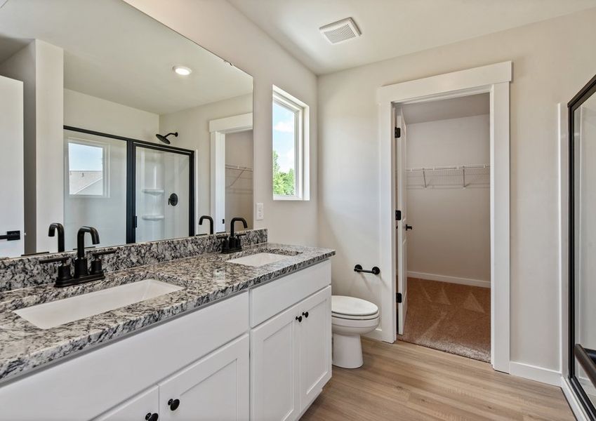 The master bathroom has a glass-enclosed shower