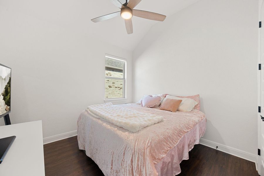 A well-lit bedroom features hard surfaced flooring and a ceiling fan for comfort. A well-lit bedroom features hard surfaced flooring and a ceiling fan for comfort.