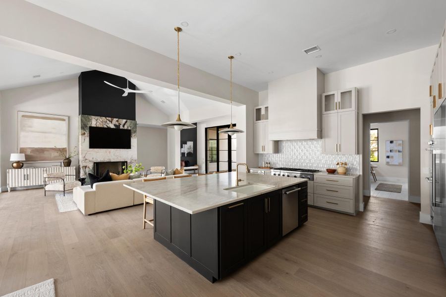 Casual dining and elite entertaining converge effortlessly around the dramatic quartz center island