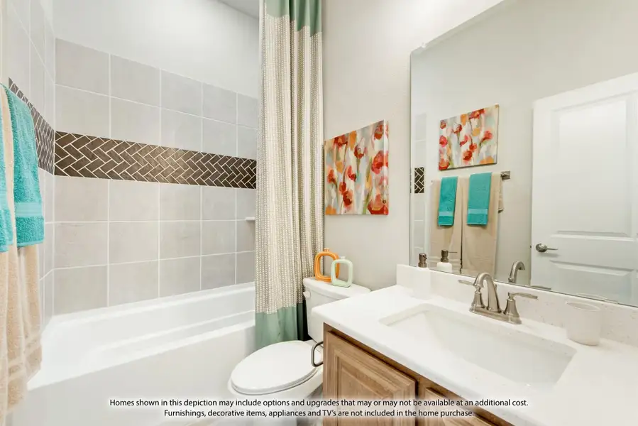 Bathroom with tiled tub-shower combo, wood vanity, white countertop, and large mirror Bathroom with tiled tub-shower combo, wood vanity, white countertop, and large mirror