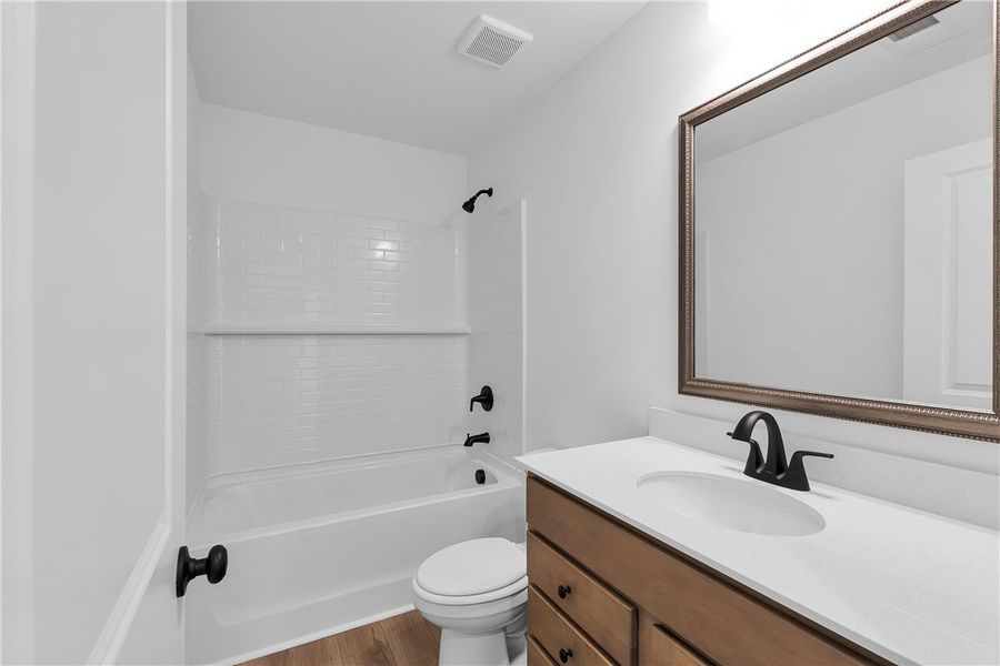 This bright bathroom features a vanity with a slee