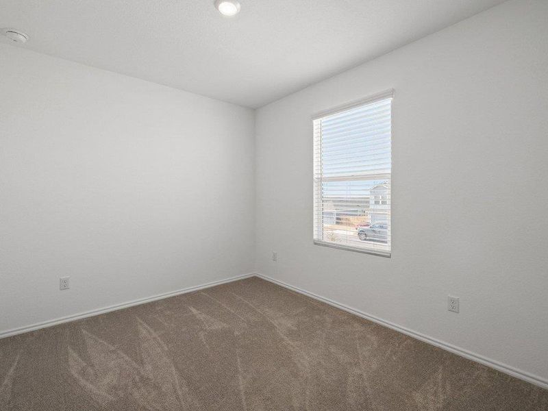 Carpeted empty room with baseboards