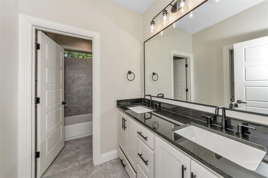 Bathroom featuring tile patterned flooring and vanity