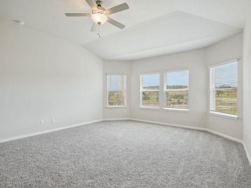 Let the sunlight stream in through the primary bedroom's bay window.