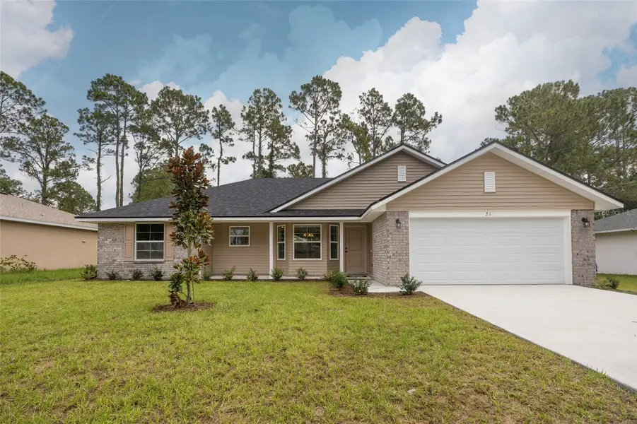Front exterior of a new home in Palm Coast, Palm Coast, FL, highlighting curb appeal (Image 1). Front exterior of a new home in Palm Coast, Palm Coast, FL, highlighting curb appeal (Image 1).