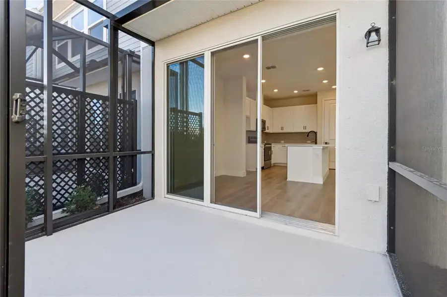 Exterior details and patio area of a home in North River Ranch – Townhomes, Parrish (Image 3).