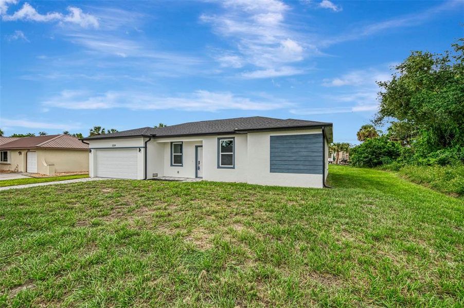 Front exterior of a new home in , Port Charlotte, FL, highlighting curb appeal (Image 23).
