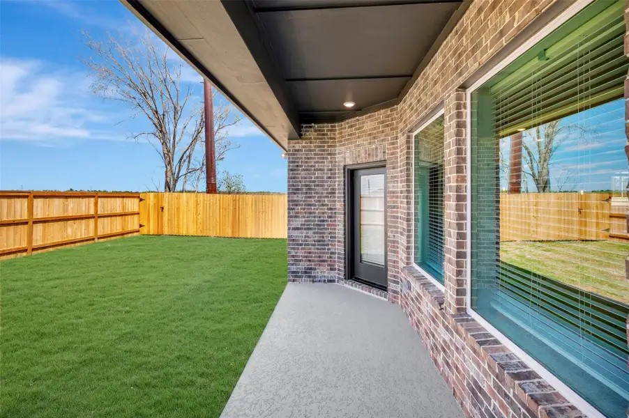 Exterior details and patio area of a home in Meridiana 55' Homesites, Manvel (Image 3).