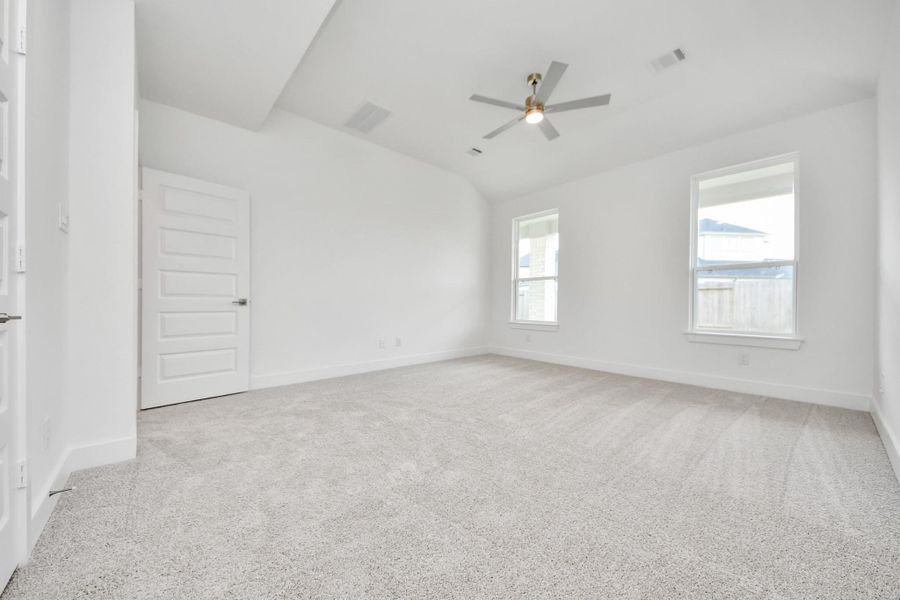Retreat to the luxurious primary suite, your perfect escape for unwinding after a long day. Located on the first floor, this spacious room features plush carpeting, calming paint tones, high ceilings, and large windows with privacy blinds. Retreat to the luxurious primary suite, your perfect escape for unwinding after a long day. Located on the first floor, this spacious room features plush carpeting, calming paint tones, high ceilings, and large windows with privacy blinds.