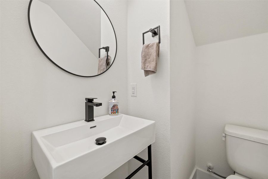 Half bathroom with a sink and toilet Half bathroom with a sink and toilet