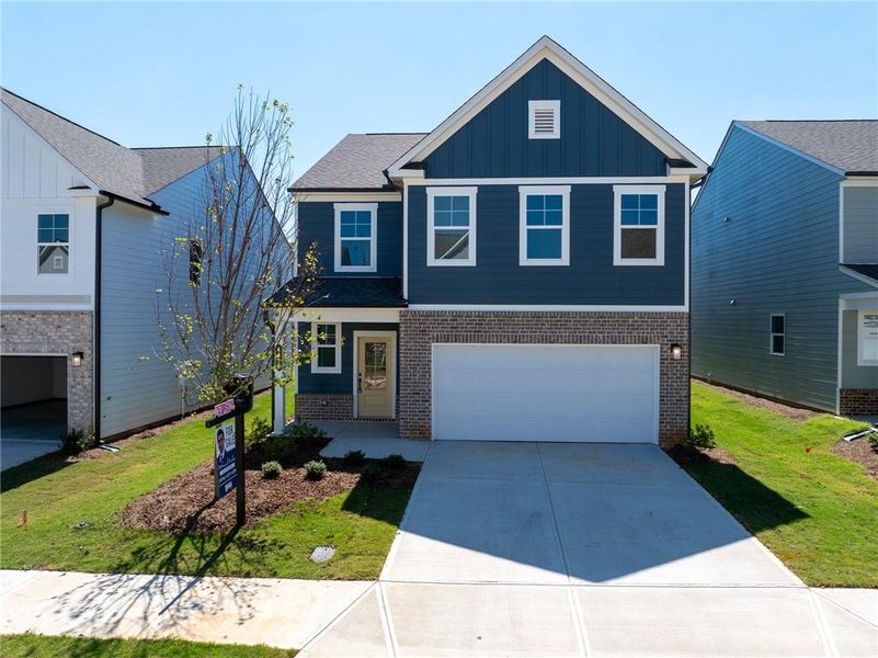 Front exterior of a new home in Annsbury Park, Lilburn, GA, highlighting curb appeal (Image 19). Front exterior of a new home in Annsbury Park, Lilburn, GA, highlighting curb appeal (Image 19).
