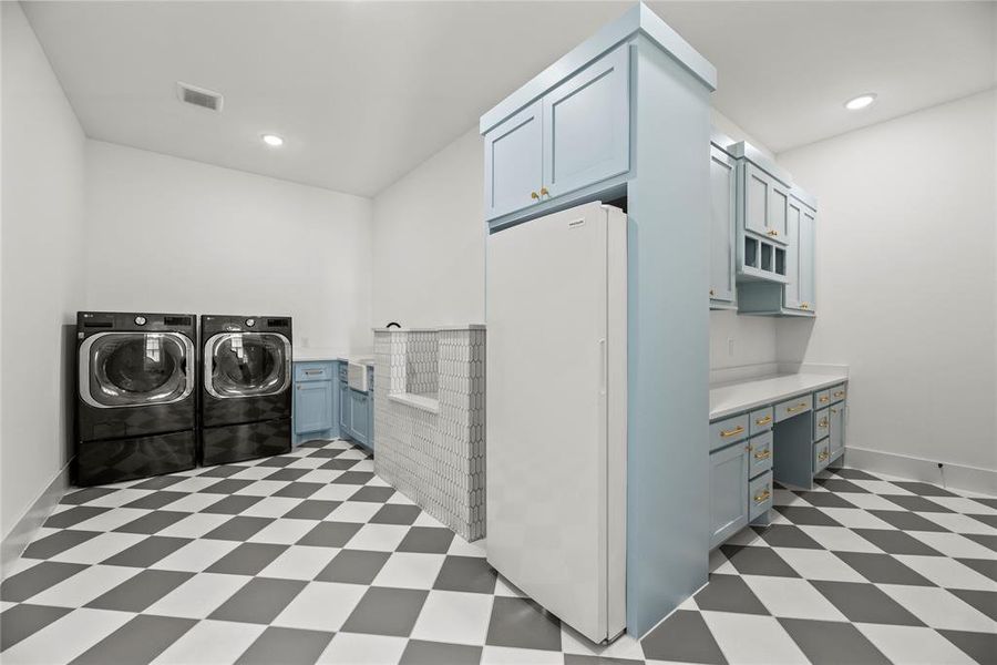 The utility space offers so much space to get the chores of the day done. A sink and room for a fridge. It's just a utility room but there even a wow factor here.