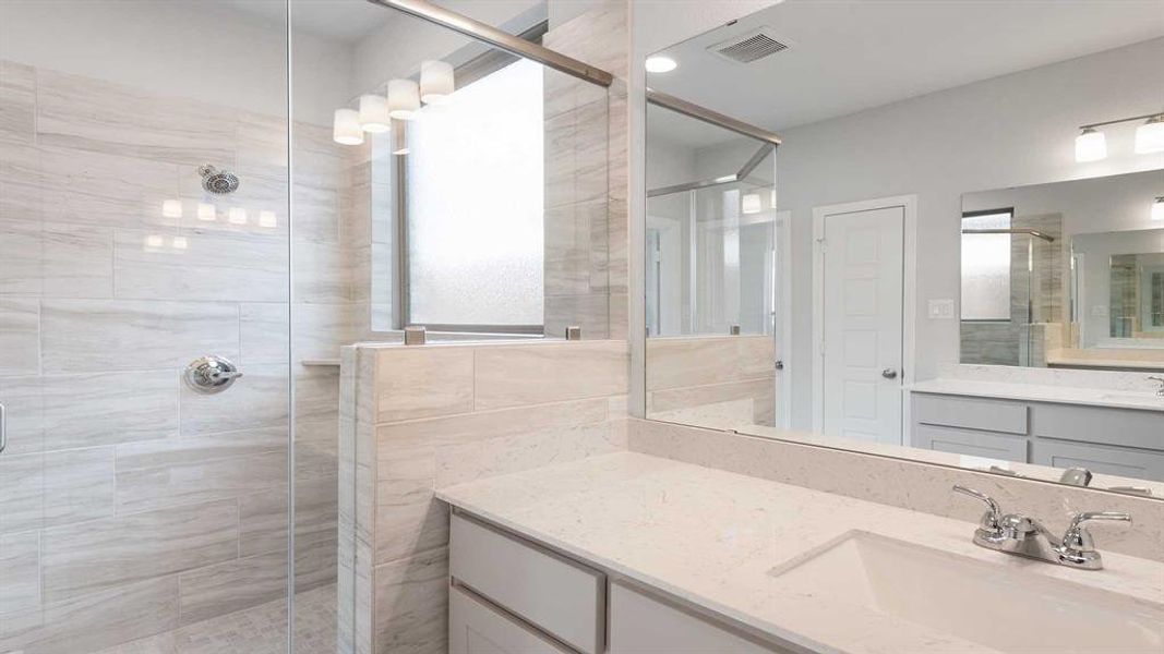 Bathroom featuring vanity and walk in shower