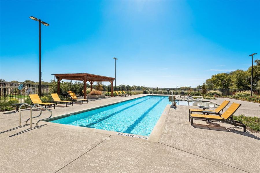Community pool with a patio area Community pool with a patio area