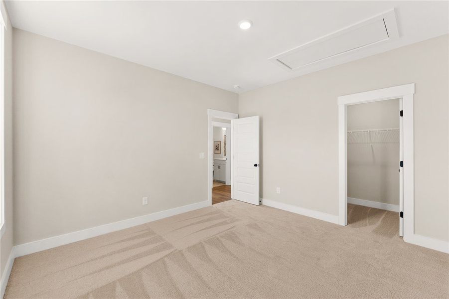 This spacious bedroom offers ample comfort and dir