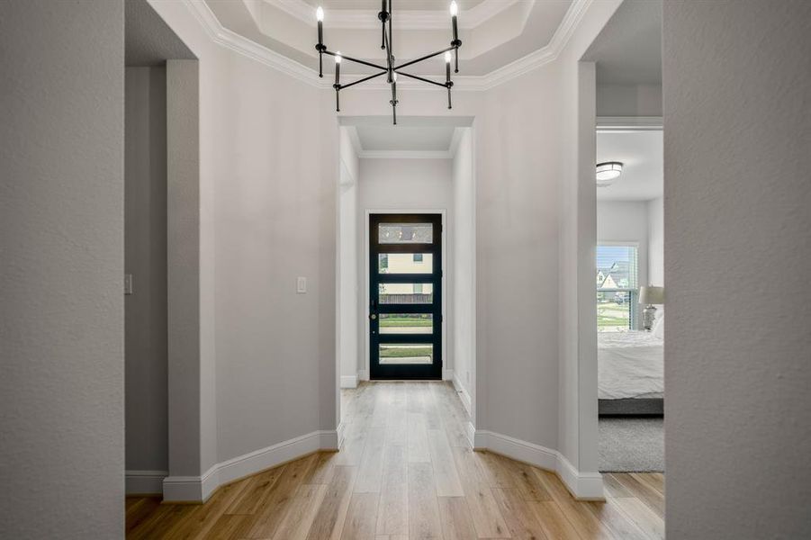 Heading back to the front of the home you see another view of the beautiful entryway leading to the front office space and secondary bedroom.