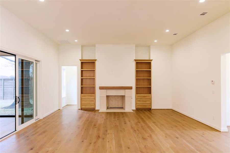 Floor to ceiling fireplace with custom built ins