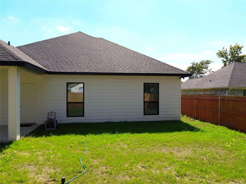 Rear view of property with a shingled roof Rear view of property with a shingled roof