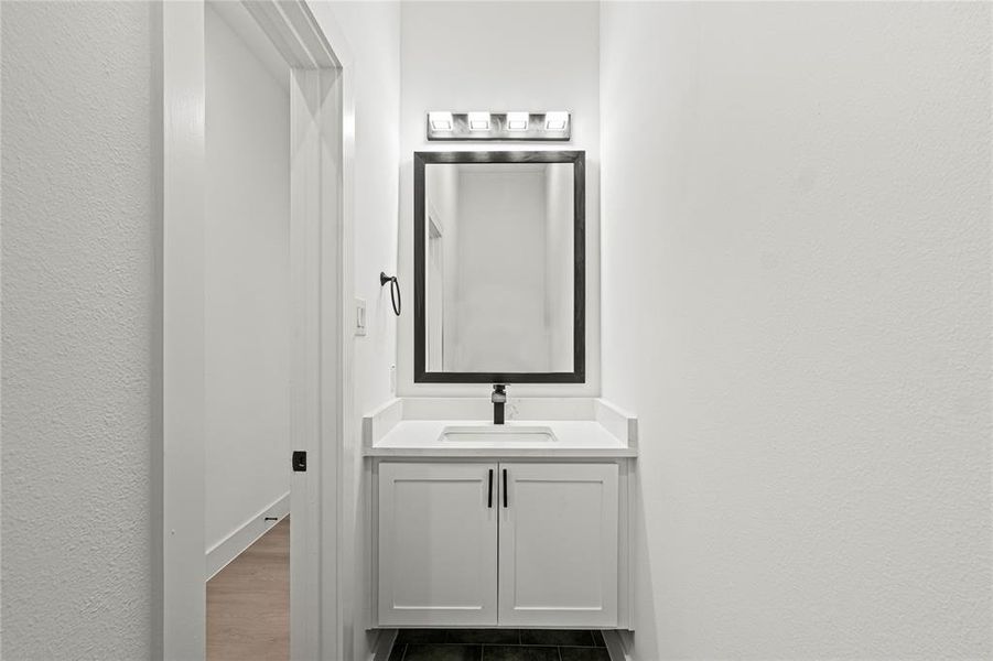 Bathroom with hardwood / wood-style floors and vanity