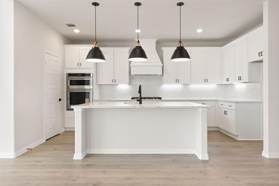 Beautiful cabinetry, charming pendant lights, neutral backsplash, gorgeous countertops, stainless appliances....what more could you ask for in your dream kitchen?