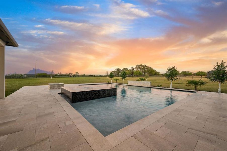 Poolside view with raised spa and sleek modern design. Poolside view with raised spa and sleek modern design.