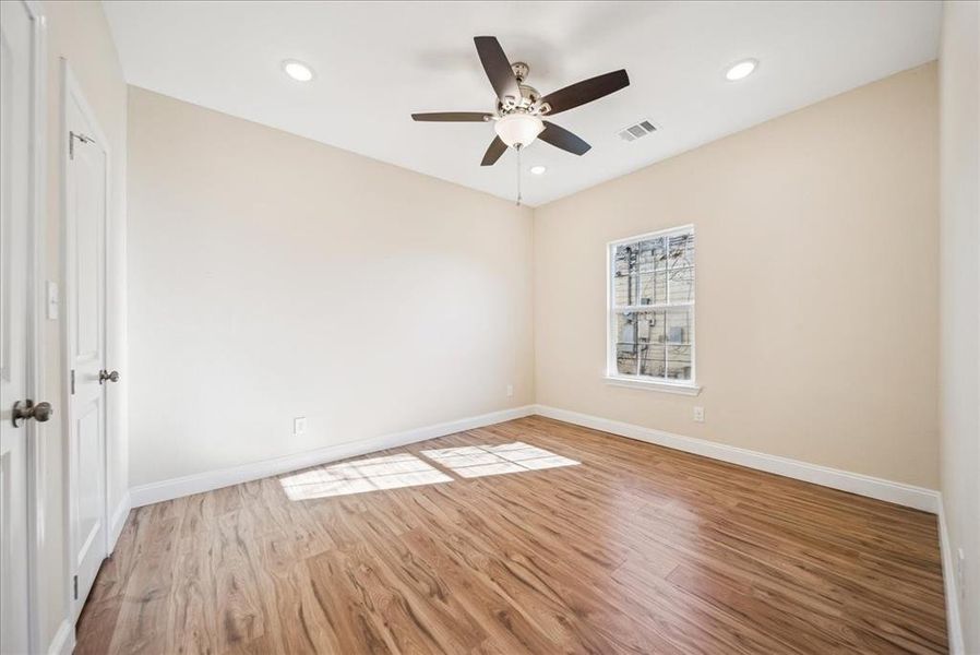 Unfurnished room with ceiling fan and hardwood / wood-style floors