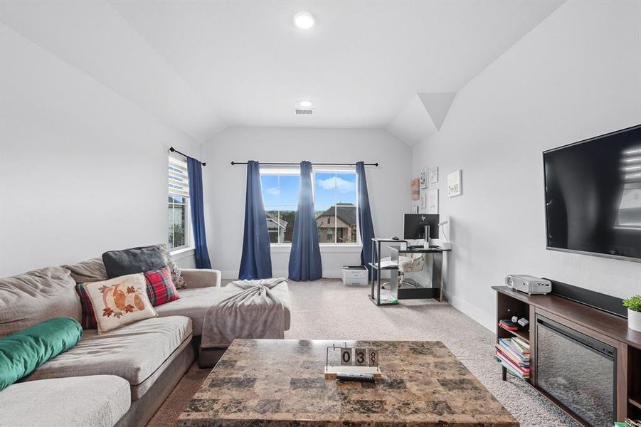 Living area with vaulted ceiling, carpet, a desk, and recessed lighting Living area with vaulted ceiling, carpet, a desk, and recessed lighting
