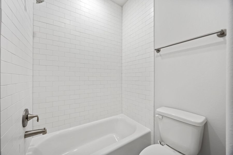 Privacy where it counts, and style that goes all the way up. Full-height tile and thoughtful design make this space a quiet standout.